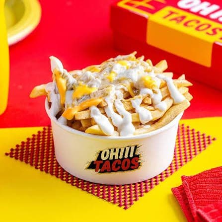 Loaded fries in a printed paper bowl